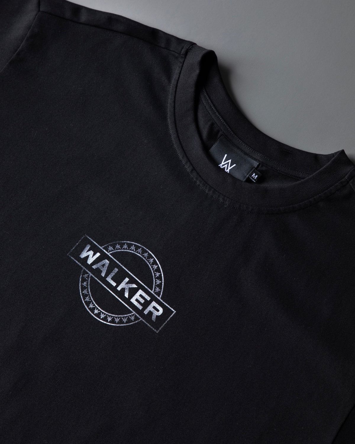 Alan Walker Monster Core T-Shirt angled chest detail, tilted WALKER stamp on soft black cotton EDM streetwear