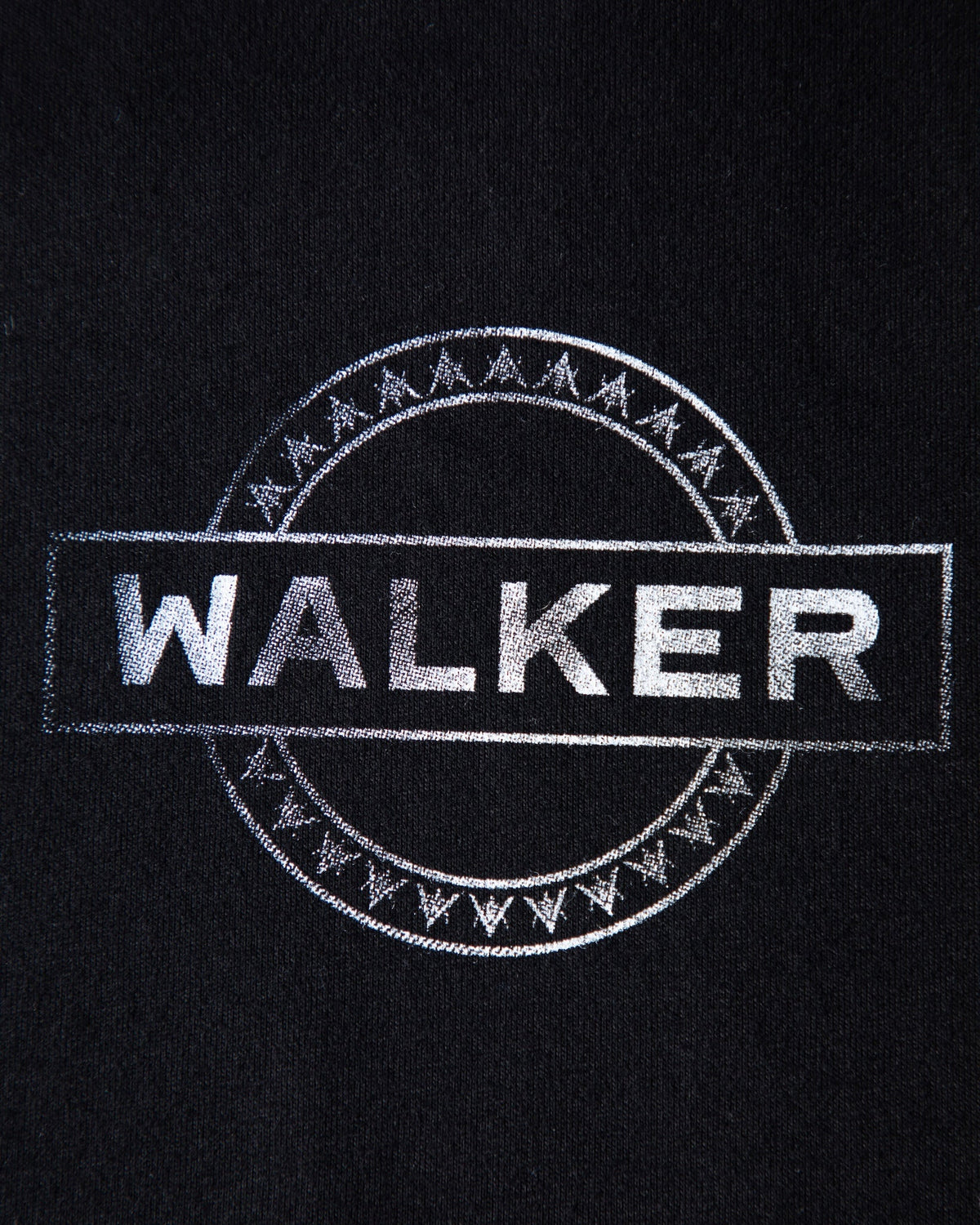 Alan Walker Monster Core T-Shirt close-up, silver Walker wordmark inside a runic circle print on black cotton