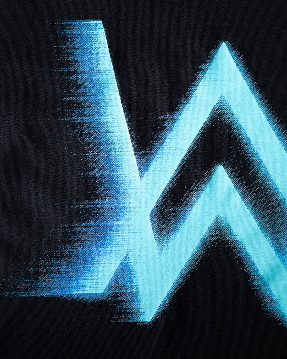 Alan Walker WRL Speed Logo T-shirt print macro showing the blue speed blur texture of the AW logo on black