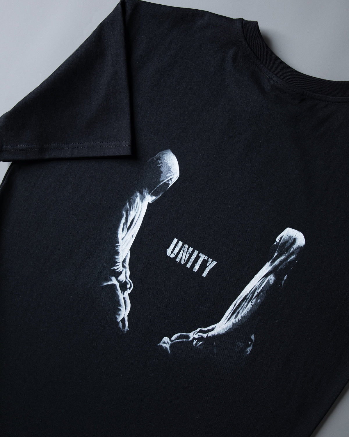 Alan Walker Tired Unity T-Shirt back print close-up, white Unity wordmark between two reaching figures