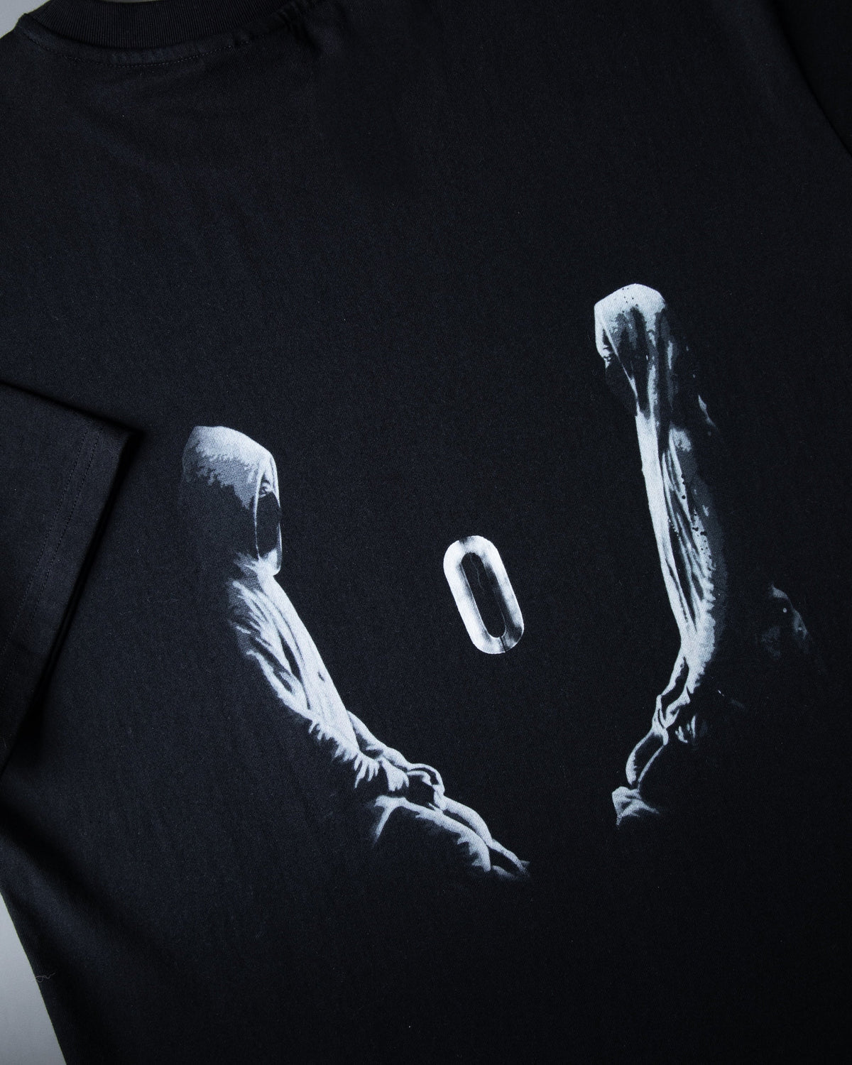 Alan Walker Tired 0 Tee back print close-up, white hooded figures reaching for the glowing zero on black