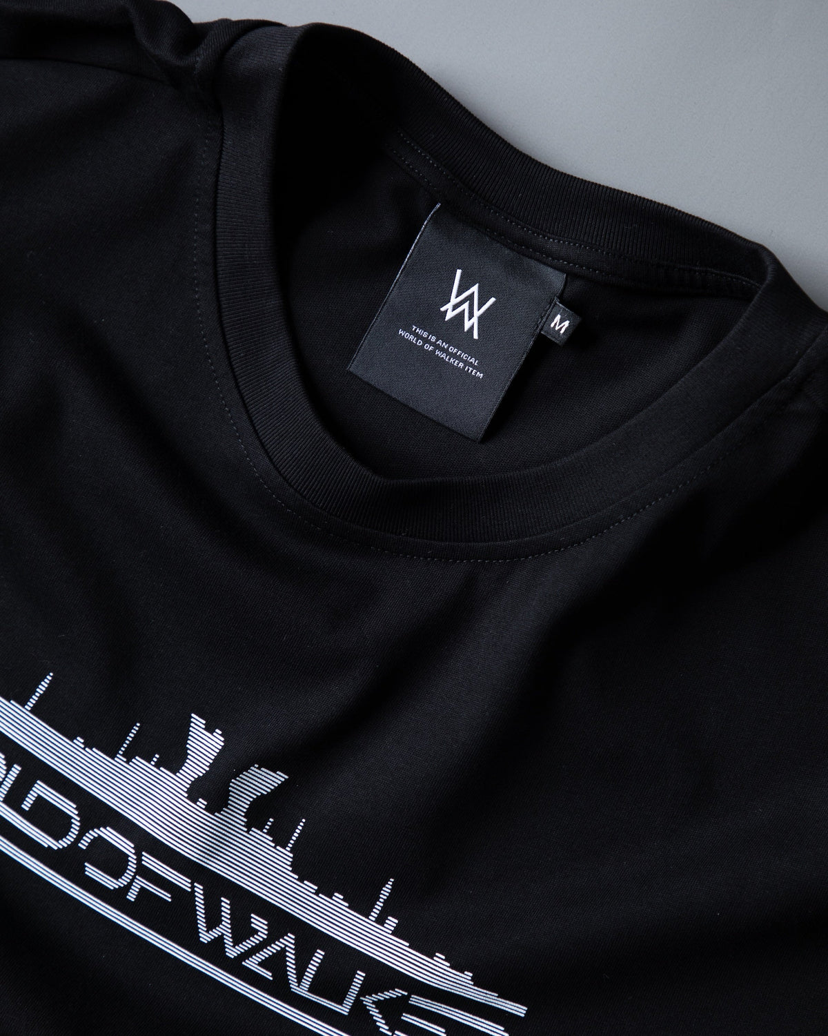 Alan Walker World of Walker Skyline T-shirt collar detail with the AW neck label above the white skyline print