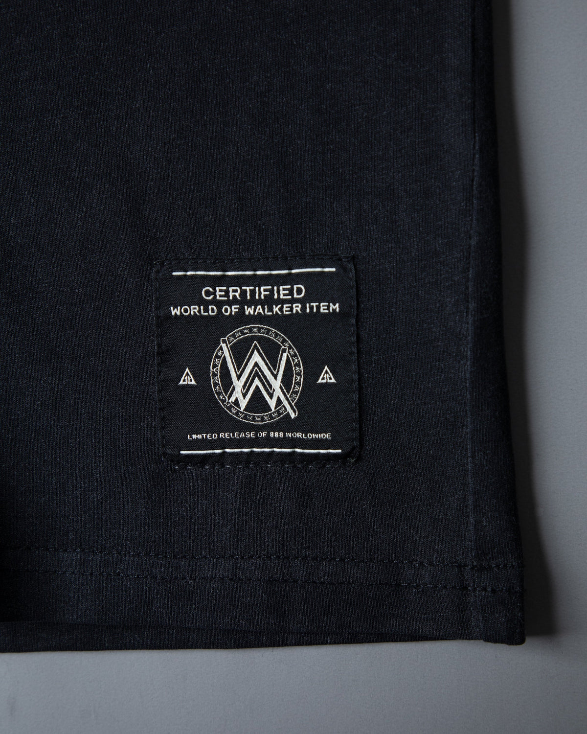 Alan Walker Faded Graffiti T-Shirt hem close-up with the black World of Walker limited label