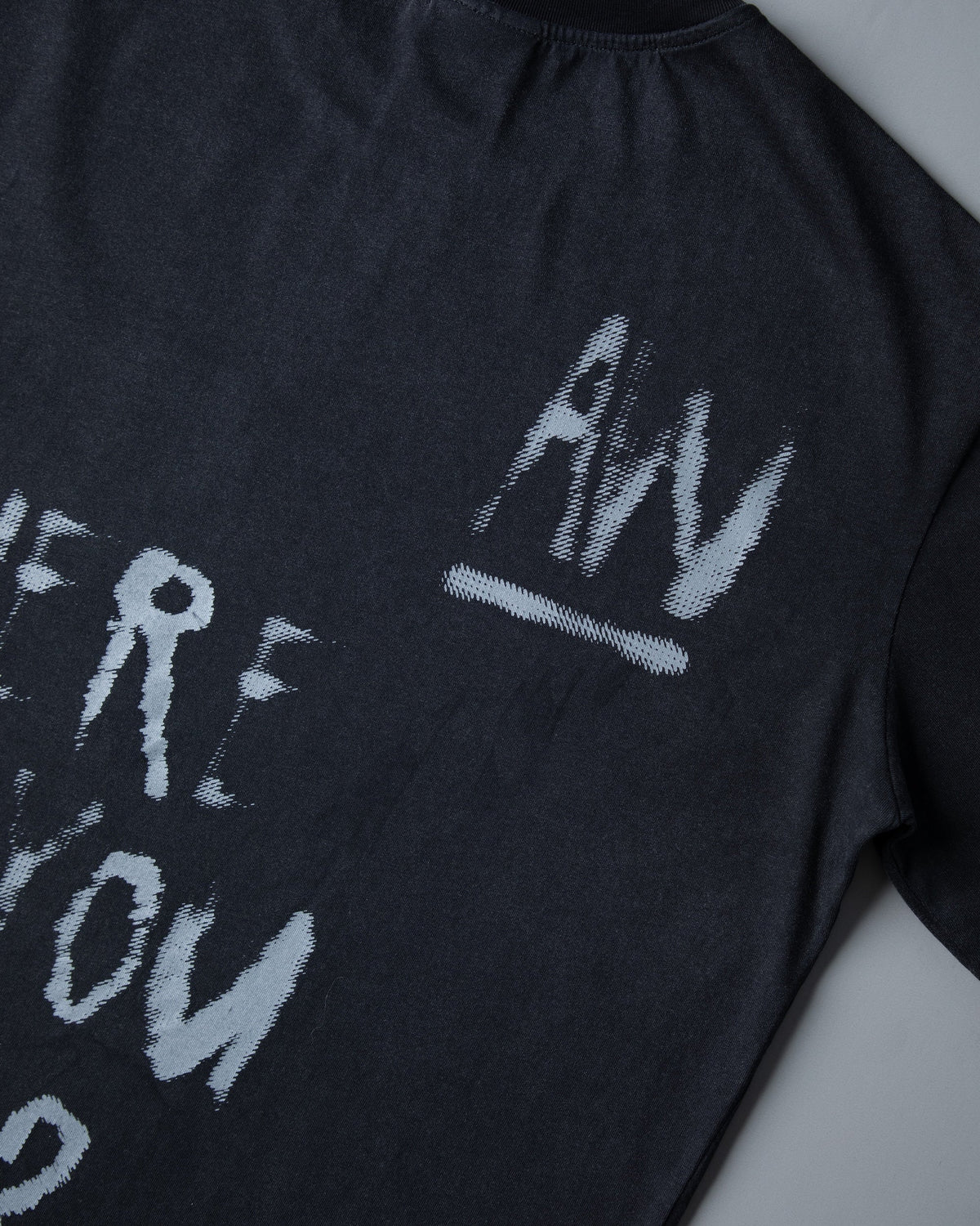 Alan Walker Faded Graffiti T-Shirt angled back detail, painted lyric and AW tag across soft black cotton