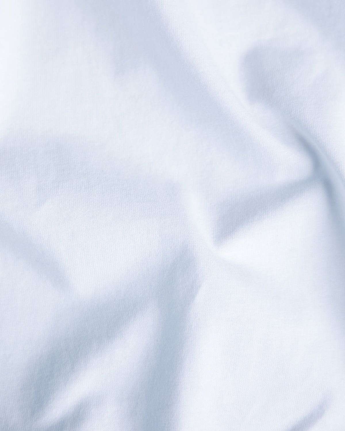 Alan Walker End of the World T-Shirt fabric close-up, soft white cotton jersey in gentle folds