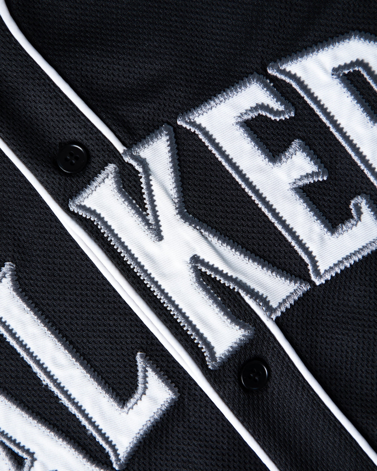 Alan Walker 0 Baseball Jersey chest detail, chunky white Walkers twill lettering beside the front buttons