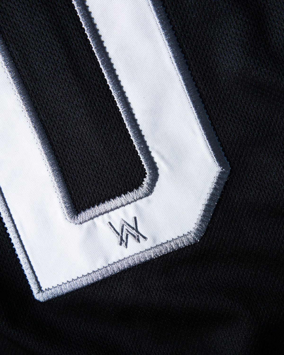 Alan Walker 0 Baseball Jersey number detail, white twill 0 patch with a small embroidered AW logo