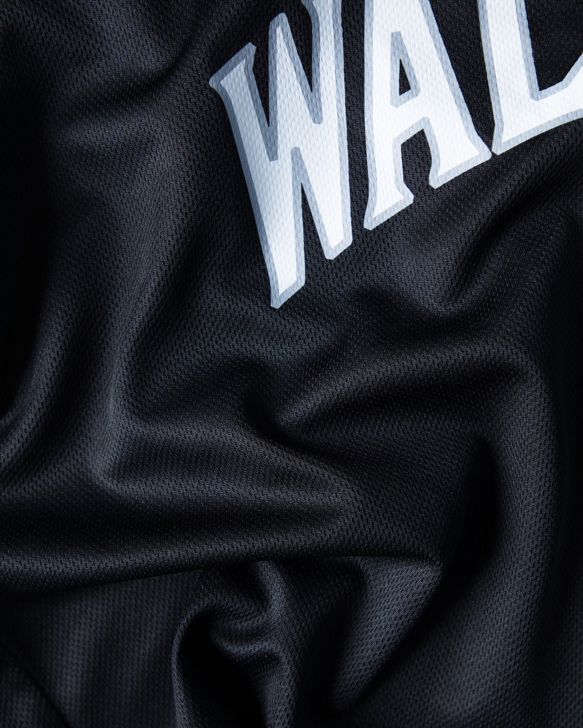Alan Walker 8 Baseball Jersey chest macro, arched white Walker letters stitched onto rippling black mesh