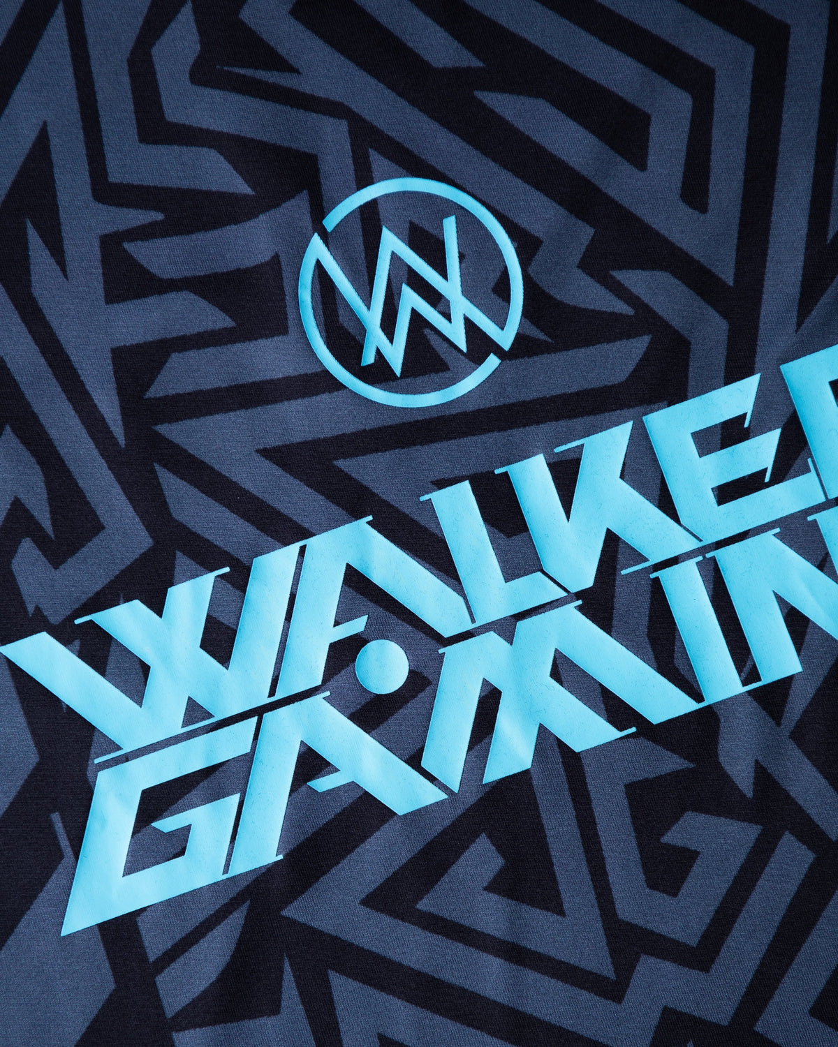 Alan Walker Gaming Jersey print macro, bright cyan Walker Gaming lettering over the navy blue angular maze graphic