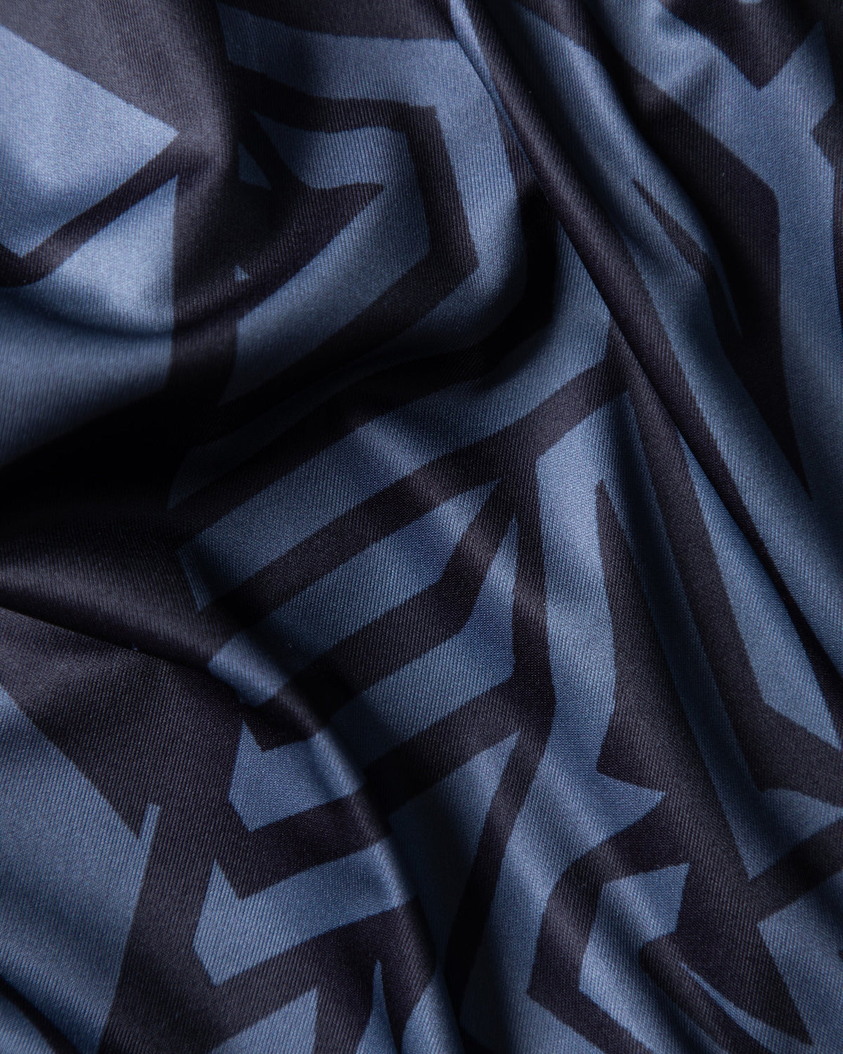 Alan Walker Gaming Jersey fabric close-up, folds of lightweight grey maze-printed performance mesh