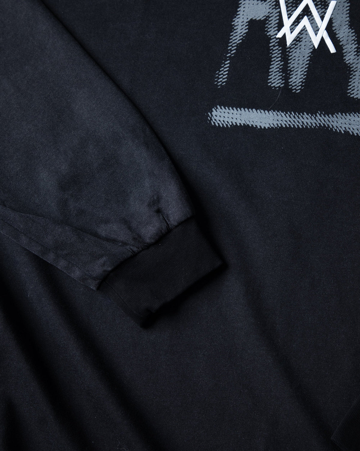 Alan Walker Faded Graffiti Longsleeve sleeve and cuff detail below the painted AW graphic on black cotton