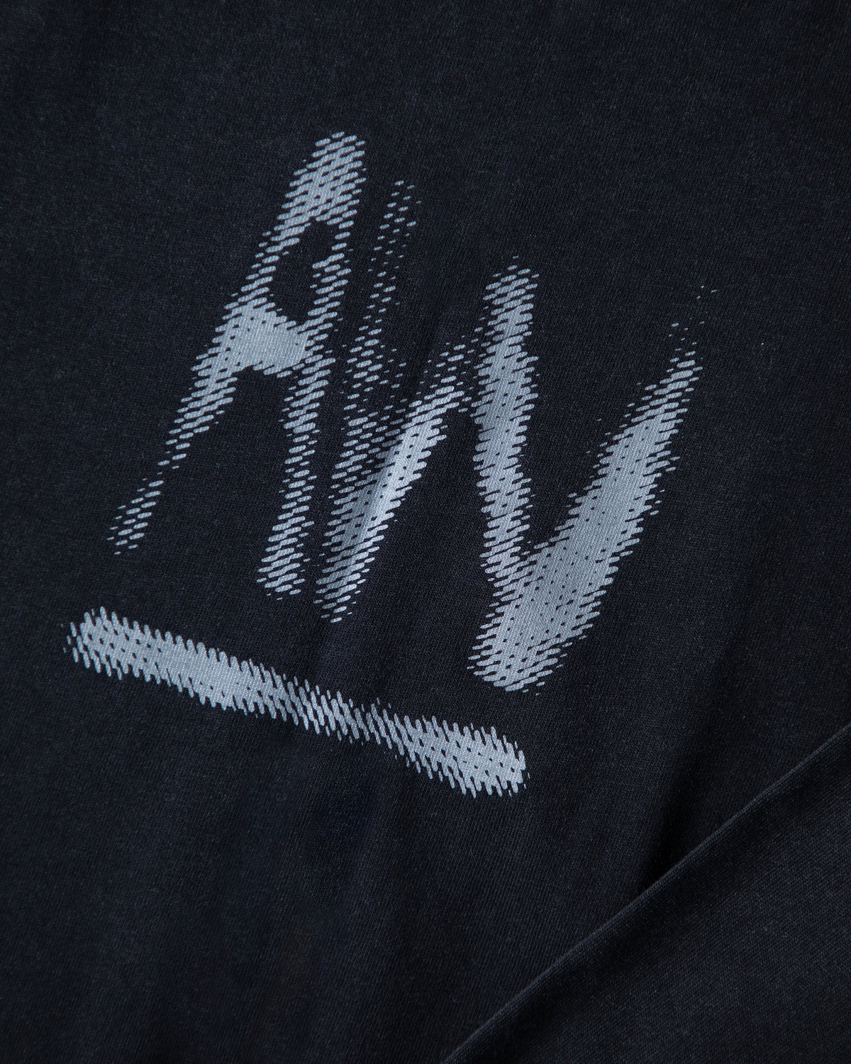 Alan Walker Faded Graffiti Longsleeve print close-up, brushed grey AW mark with a bold underline on black