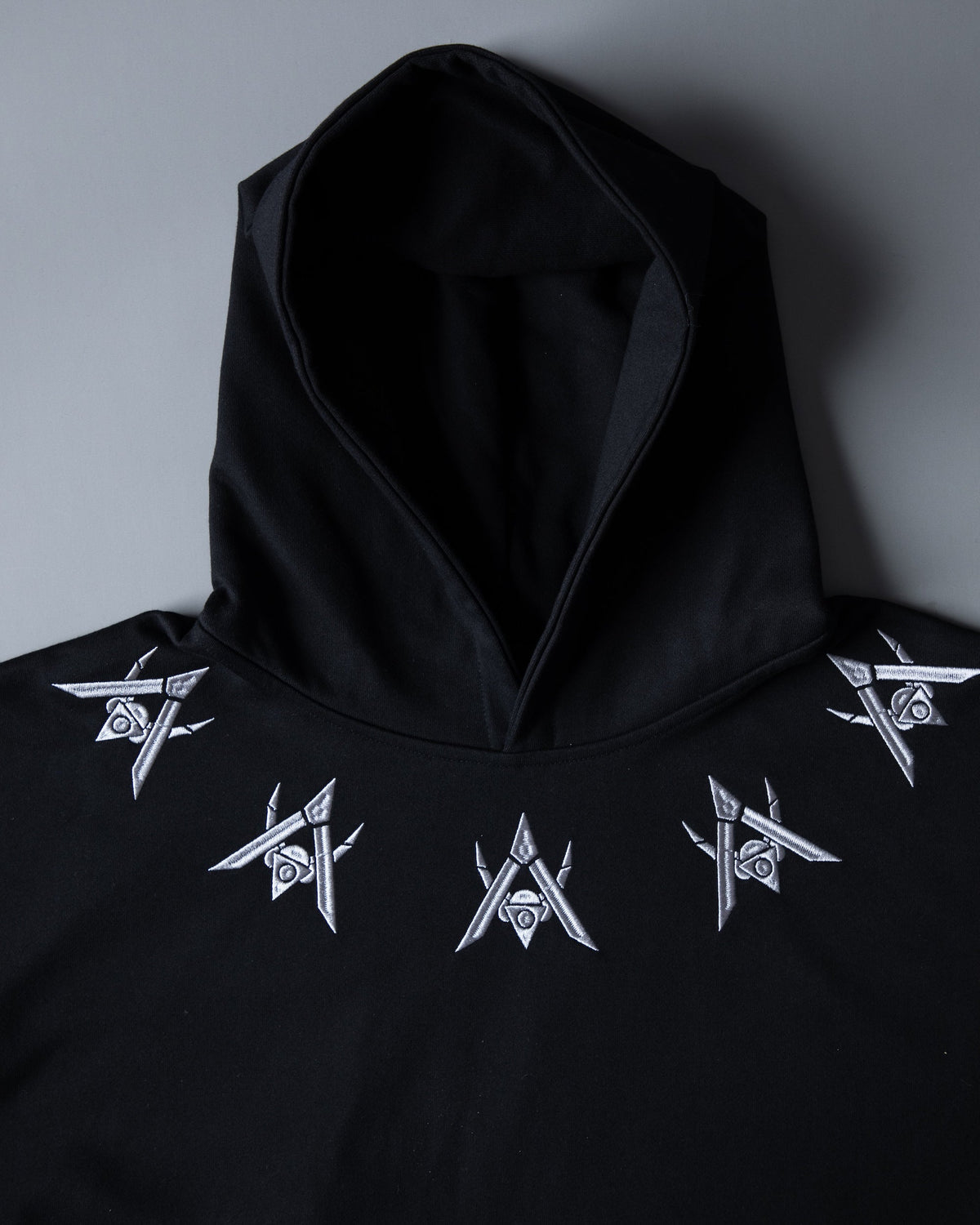 Alan Walker Rise of the Drone Bundle AV8 hoodie close-up, silver drone motifs printed across the black hood