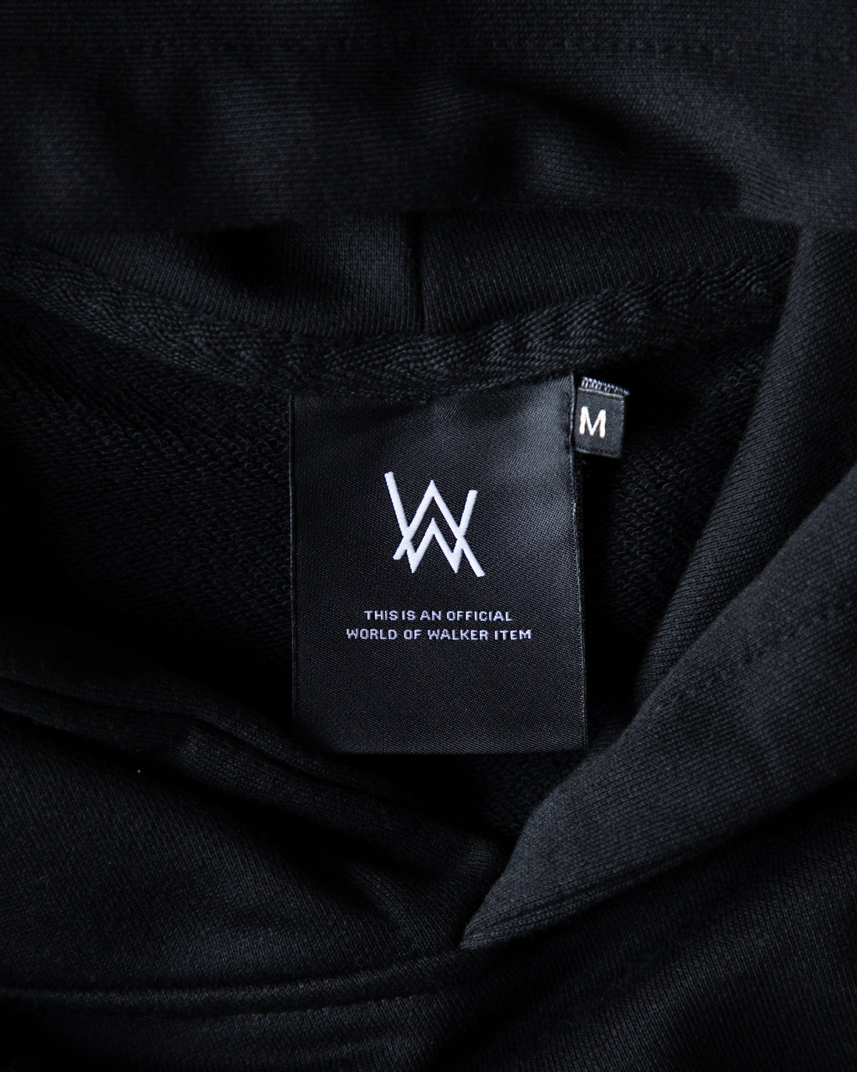 Alan Walker Tired Unity Hoodie inner neck detail, black AW World of Walker label on the fleece