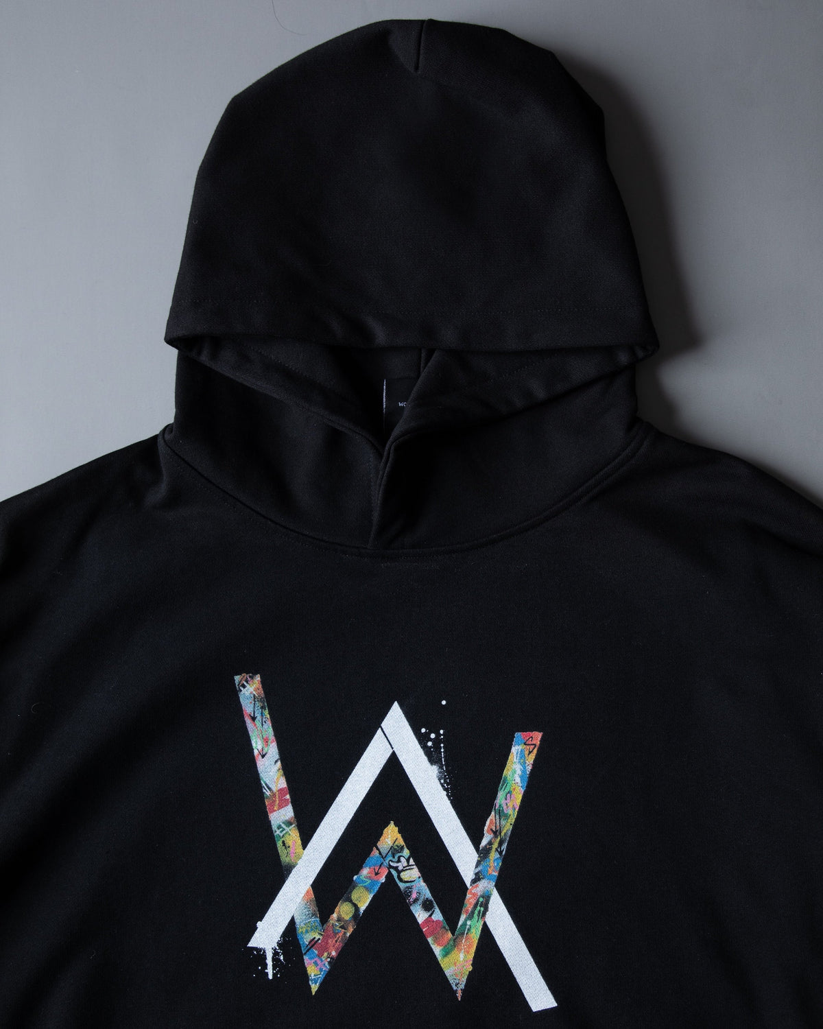 Alan Walker Tired 0 Hoodie front detail, floral-fill AW chest logo in colour on heavyweight black fleece
