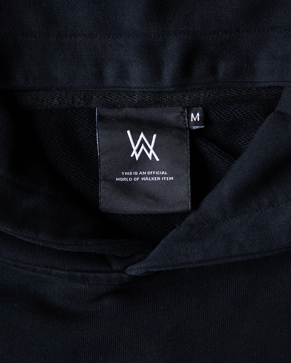 Alan Walker Faded Graffiti Hoodie neck close-up, black World of Walker inner label on heavy black fleece