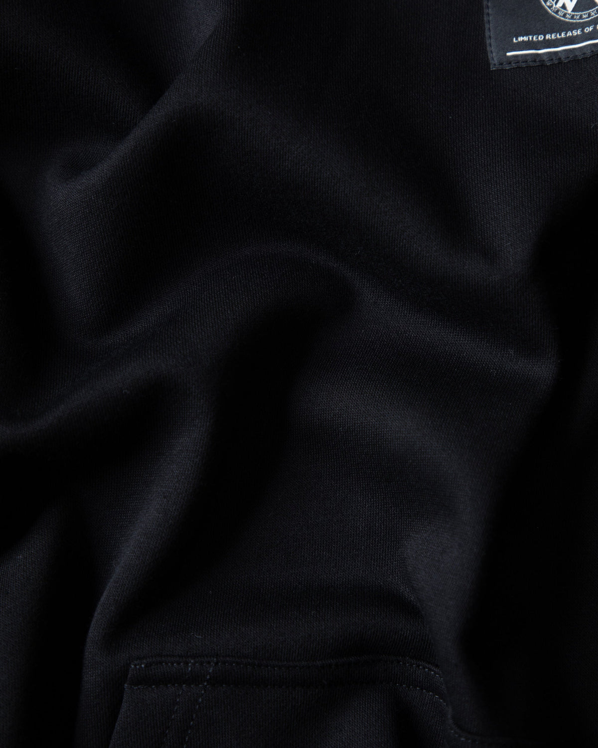 Alan Walker Prophecy Disc VIII Hoodie fabric close-up, heavyweight black fleece with limited release neck tag
