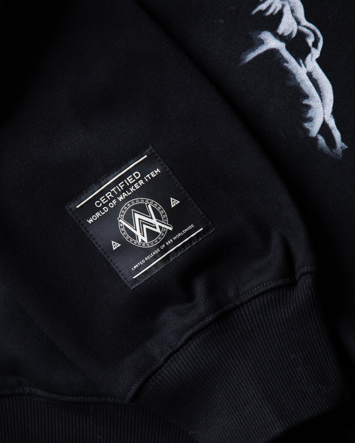 Alan Walker Tired Unity Hoodie hem detail, Walker label beside the white Unity figure print