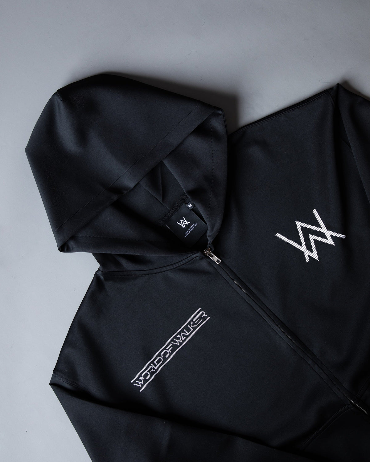 Alan Walker World of Walker Skyline Zip Hoodie folded detail, white AW logo, zip pull and World of Walker tape