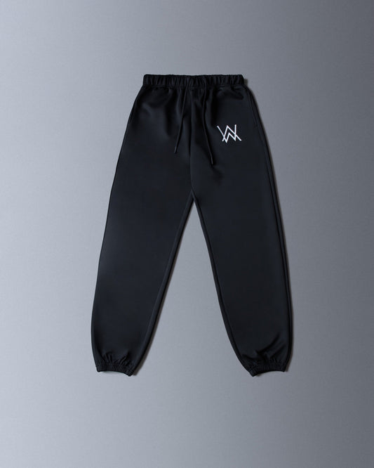 Alan Walker World of Walker Skyline Sweatpants black flat lay, tapered joggers with small white AW hip logo