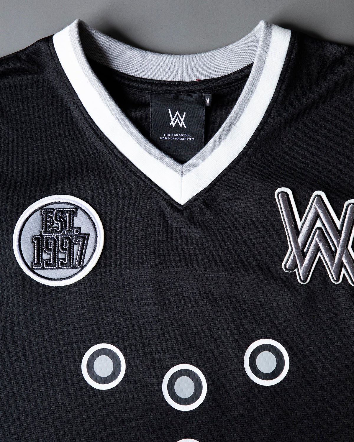 Alan Walker 0 Hockey Jersey front close-up with Est 1997 patch, AW logo and grey ring graphics on black