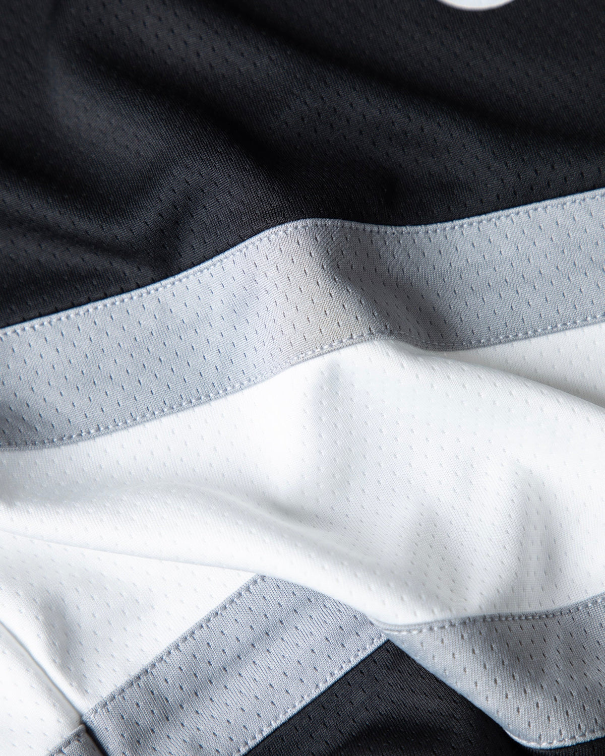 Alan Walker 0 Hockey Jersey fabric close-up, soft folds across the white and grey chest stripe panel
