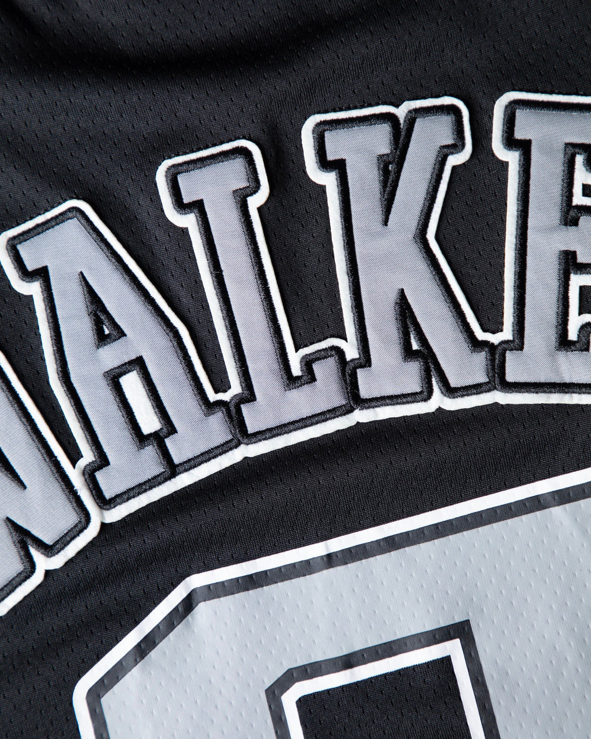 Alan Walker 0 Hockey Jersey lettering macro, grey twill Walker letters appliqued onto black mesh