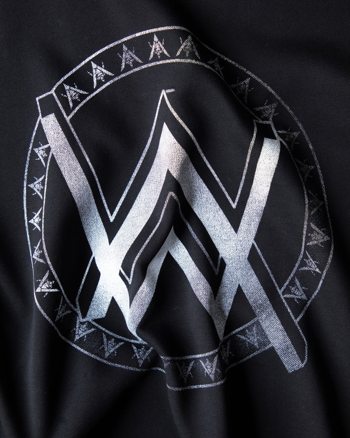 Alan Walker Monster Core Hoodie back print close-up, silver AW logo inside a runic circle on black fleece