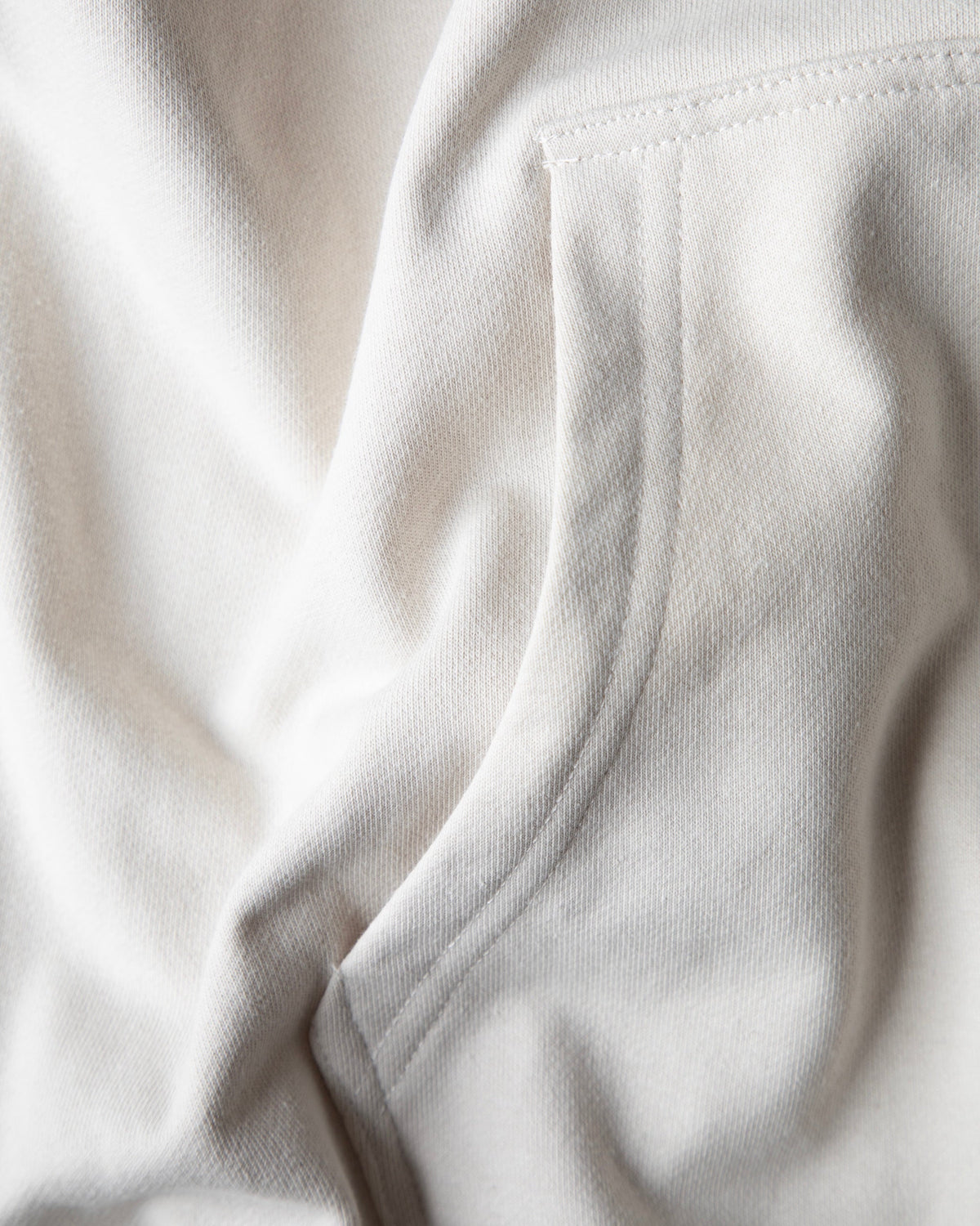 Alan Walker Encyclopedia Hoodie fabric close-up, brushed off white fleece falling in soft heavyweight folds