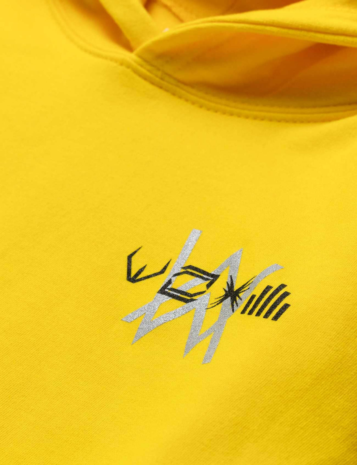 Alan Walker Walkerverse Stage Kids Hoodie chest print close-up, silver Walkerverse symbols on yellow fabric
