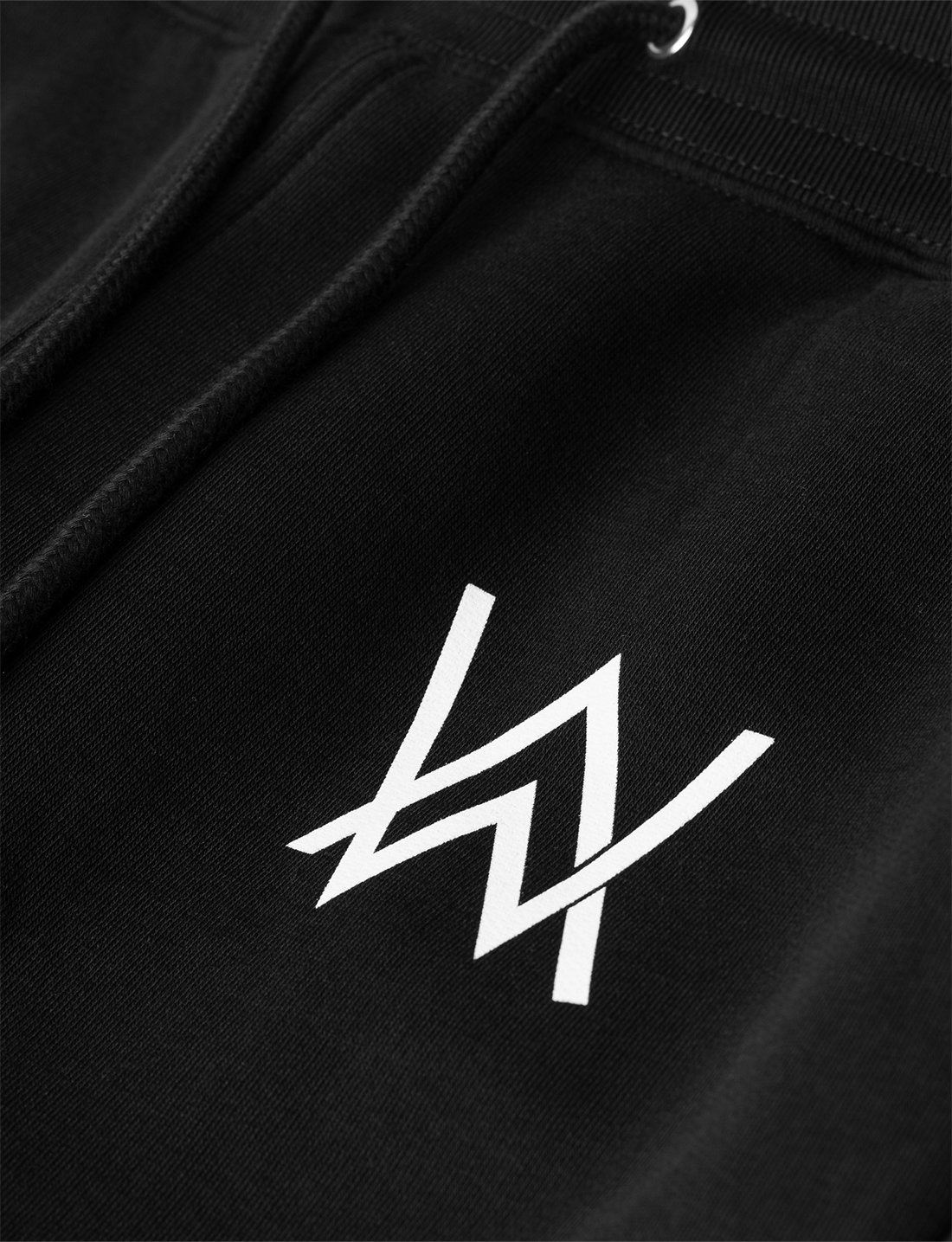 Alan Walker Core Drone Sweatpants thigh detail, white AW logo printed on soft black cotton fleece