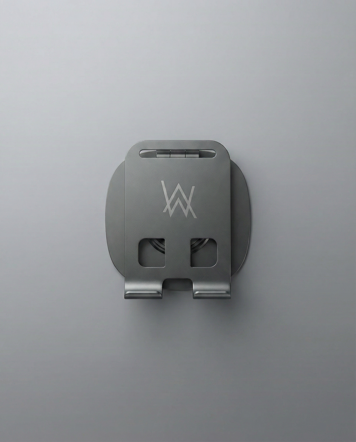 Alan Walker Logo Phone Stand shown folded flat from above, compact grey plate with engraved AW emblem