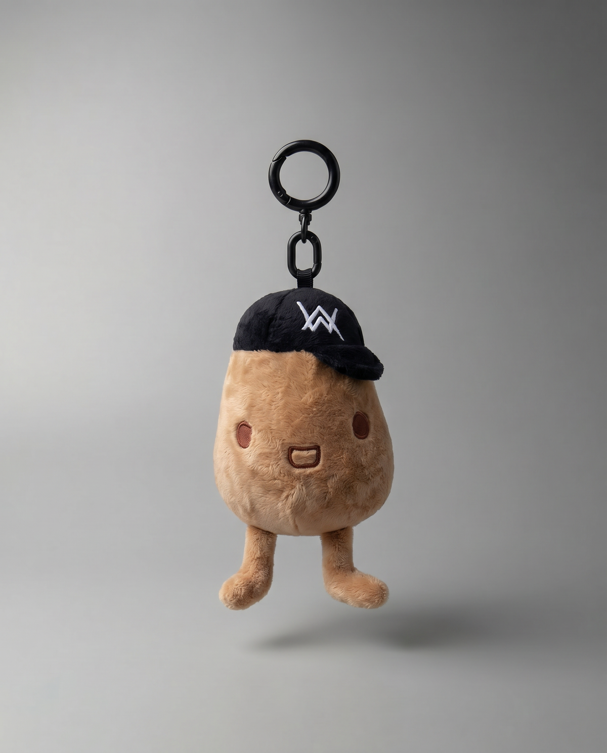 Alan Walker Tato Plushie keyring, brown plush potato in a black AW cap hanging from a metal clip