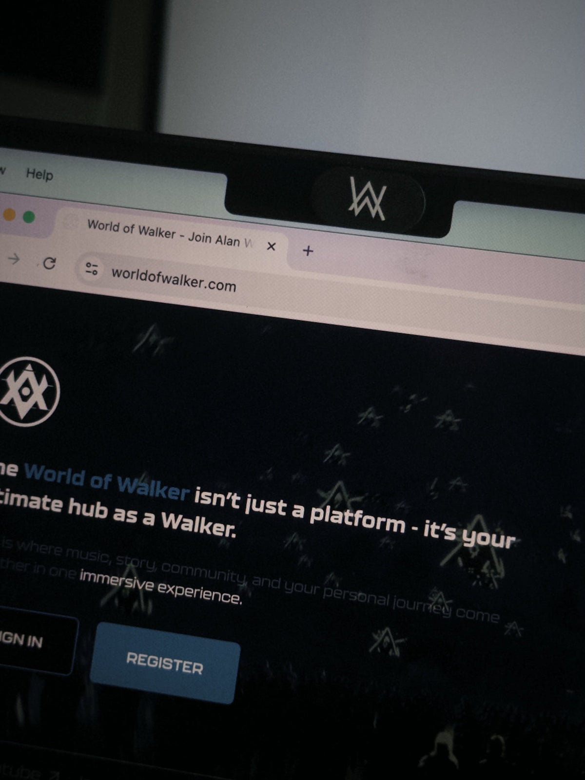 Alan Walker Webcam Cover in use on a laptop, AW logo slider fitted above the screen on the World of Walker site