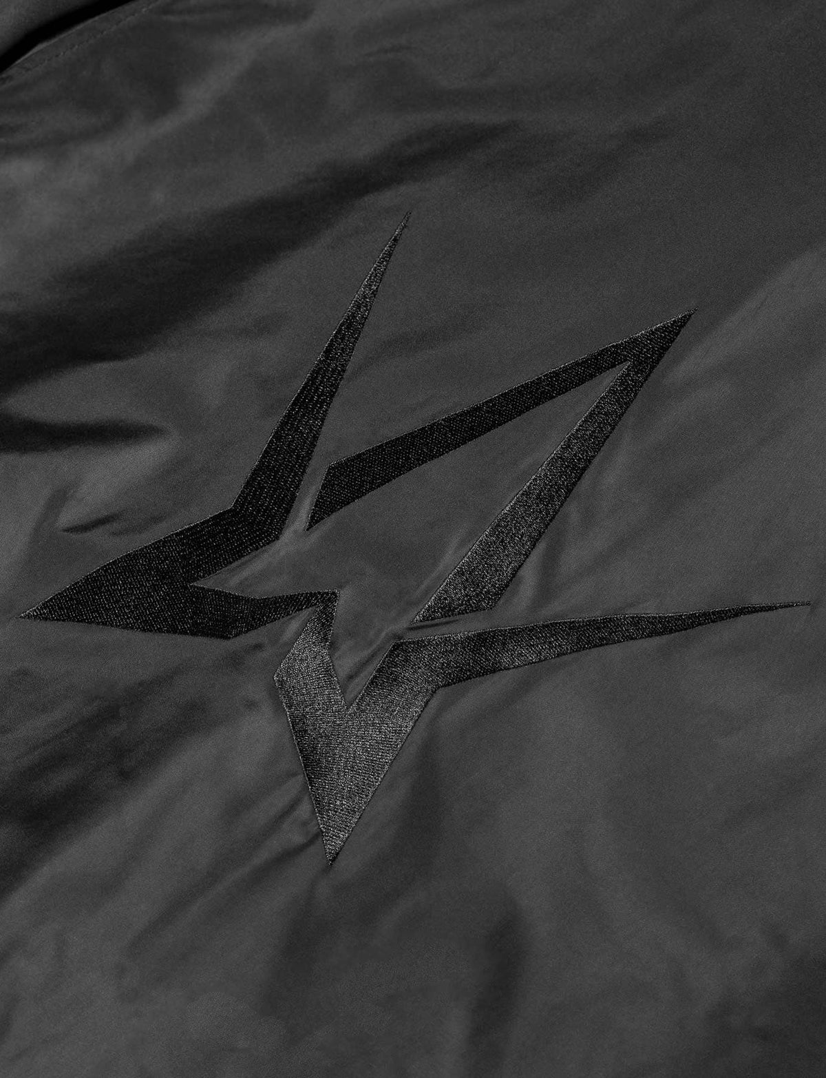 Alan Walker Walkerverse Bomber Jacket back print close-up, matte black Walker star on the sheen fabric