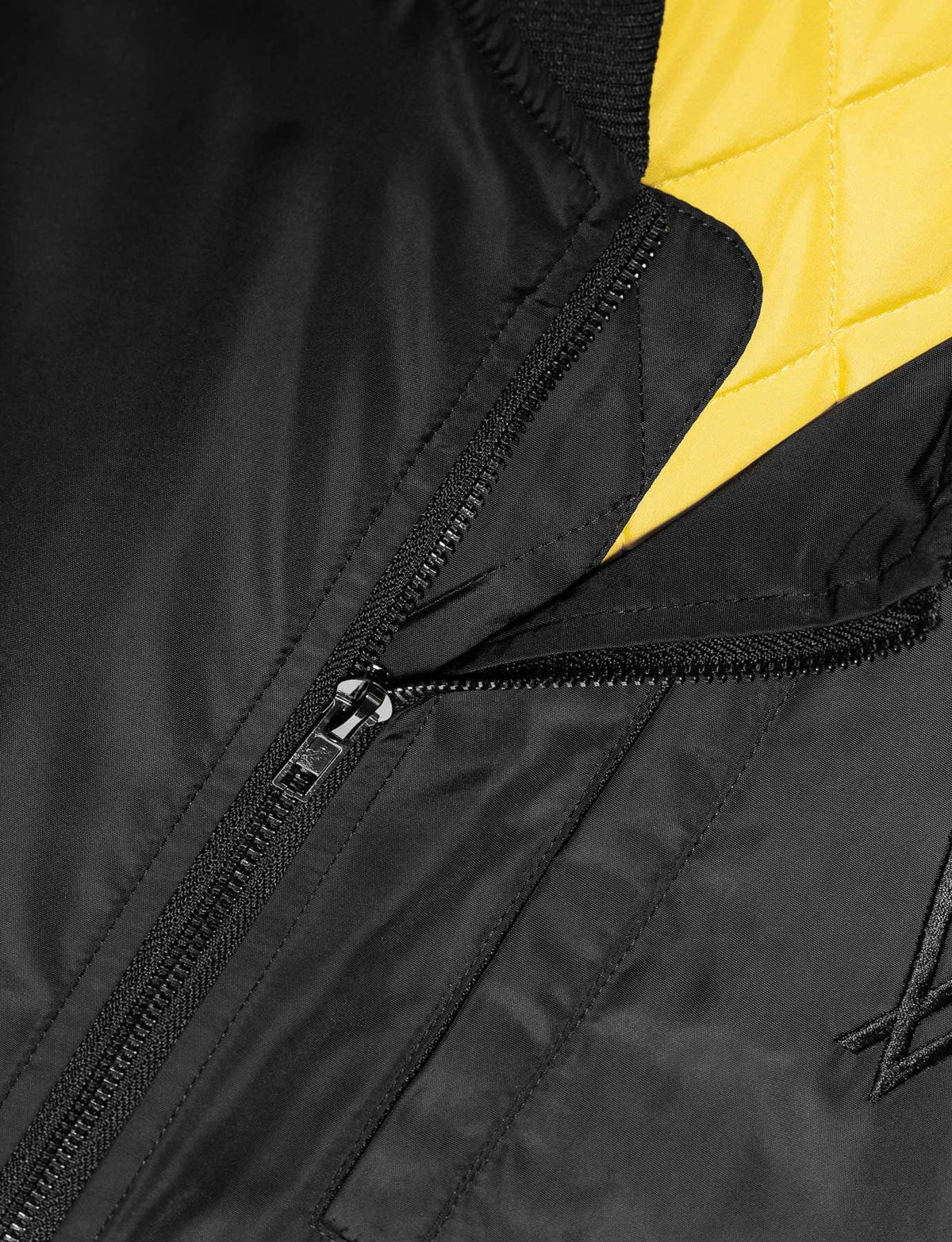 Alan Walker Walkerverse Bomber Jacket open front showing the quilted yellow lining behind the black zip