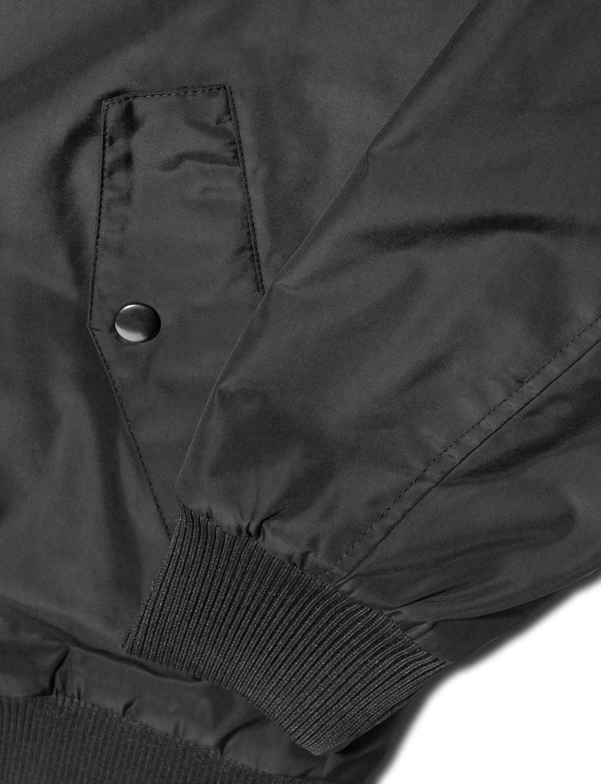 Alan Walker Walkerverse Bomber Jacket pocket and cuff detail, snap flap above the ribbed black hem