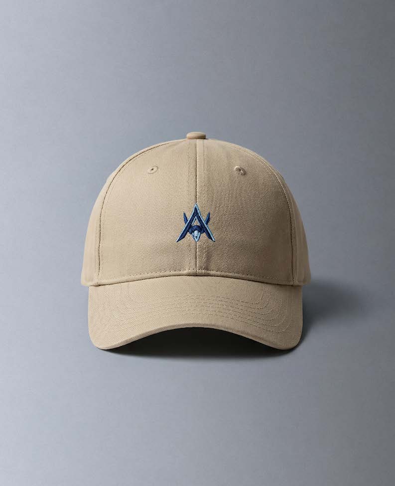 Alan Walker AV8 Cap front view, sand coloured baseball cap with a navy embroidered AW logo on the crown