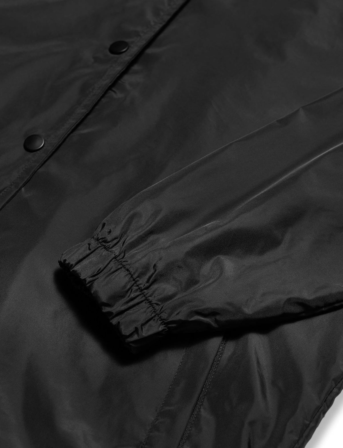 Alan Walker Walkerverse Crew Jacket cuff and snap close-up on the matte black weather-resistant shell