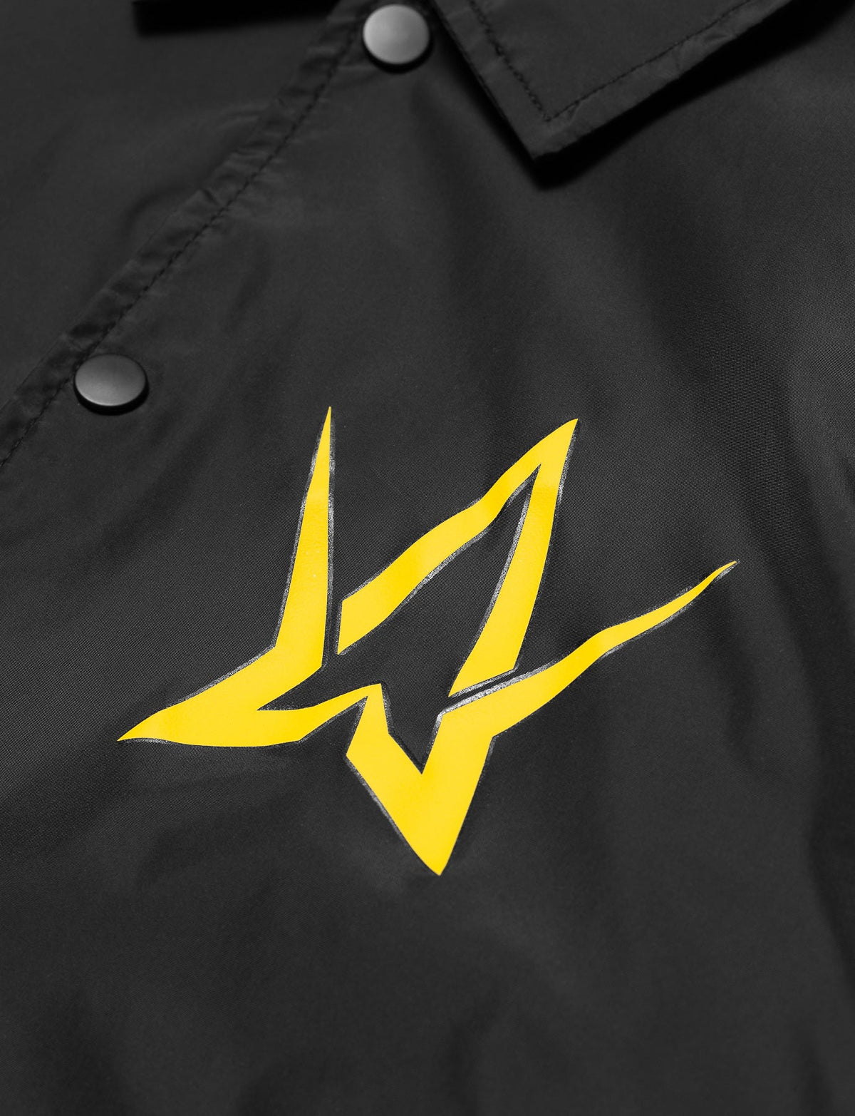 Alan Walker Walkerverse Crew Jacket chest print close-up, bright yellow AW logo on black nylon shell