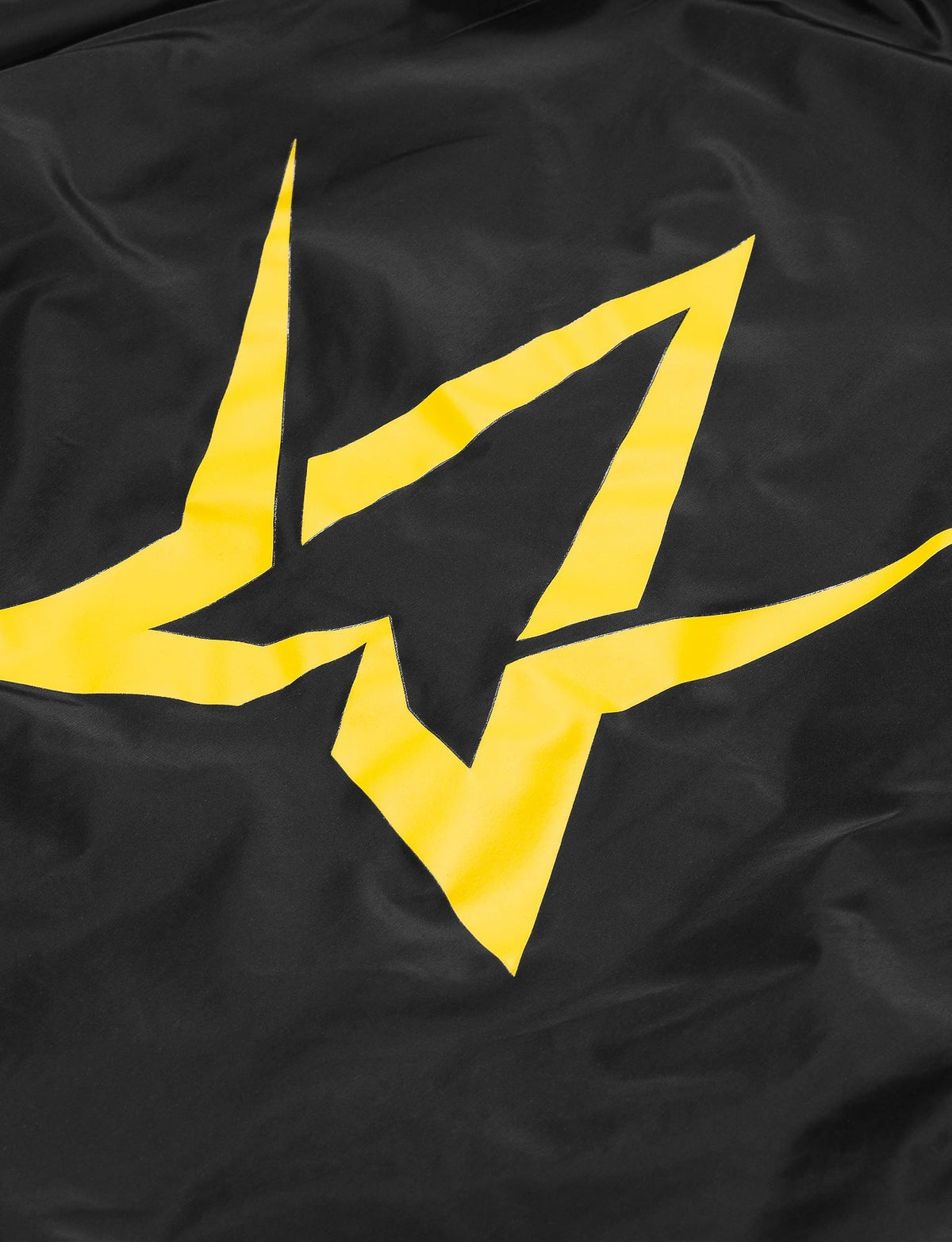Alan Walker Walkerverse Crew Jacket back close-up, large yellow Walker star logo printed on black nylon shell